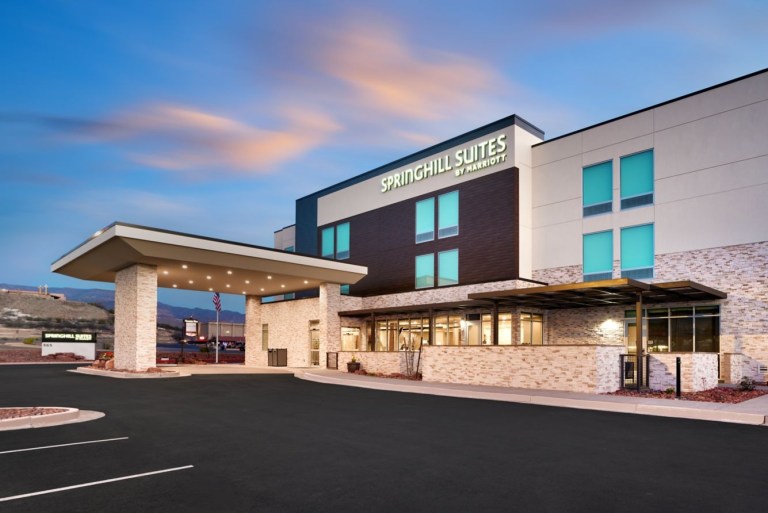 Modern hotel building with Springhill Suites sign and large entrance canopy.
